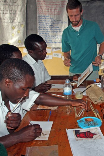 Teaching students to paint using eggs and dirt.